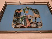 Full view of blue glass tray showing frame and handles