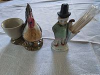 Hen egg cup and boy toothpick holder on table