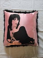 Front view showing pink satin fabric with black portrait graphic