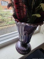 Full view of slag glass pedestal vase with filler