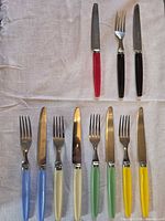 All ten cutlery pieces laid out showing colour range and overall condition