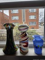 Front view of all three glass vases on windowsill