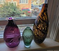 All three vases together on windowsill showing colors and shapes