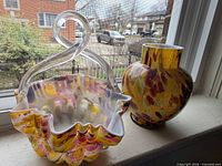 Ruffled basket and bulbous vase on windowsill, clear view of colors and shapes