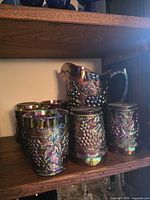 Pitcher and six tumblers grouped on shelf