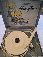 Open case showing platter, tonearm, interior graphic and branding