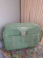 Front view of green Samsonite faux leather messenger bag