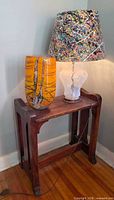 Wood side table, glass lamp and yellow vase full view