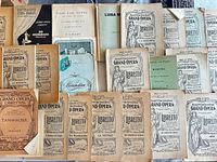 Overhead view of approximately 24 vintage Metropolitan Opera House Grand Opera librettos published by Fred Rullman, Inc., various titles visible