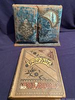 Scrapbook and closed velvet photo album side by side