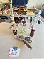 Full lot on table showing shaker, multiple shot glasses, strainer