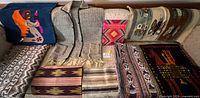 Group shot of all textiles, jacket and book displayed on couch