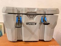 Front view of closed cooler showing Lifetime logo, latches, overall exterior condition