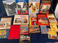 Overview of fourteen postcard books and booklets laid out