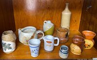 Group shot of all eleven ceramic items on shelf
