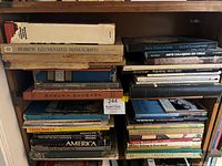 Bookshelf showing multiple art, history and travel books in two vertical stacks and top horizontal stack