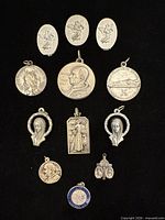 Full group shot of all eleven pendants on black background