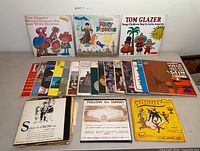 Overview of approximately 27 children’s and world music vinyl records laid out on table, showing key titles Mary Poppins and Tom Glazer albums