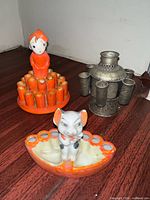 Bellhop cigarette holder, cow ashtray and metal inkwell grouped