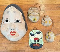 Group shot of all five masks on wood floor