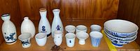 Full set showing three carafes, eleven cups, three bowls