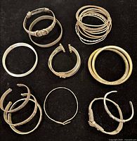 Overhead view of entire assortment of bangles and bracelets on black background