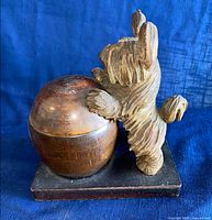 Side view showing terrier and humidor on base