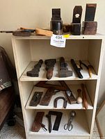 Overall view of shelf with planes, mallet, clamps, squares, scissors