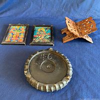 Group shot of all items: two framed prints, folding stand, round pedestal