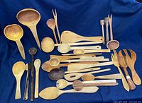 overview of entire assortment of wooden utensils on blue background