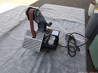 Full view of Enco 1" belt sander with power cord on table
