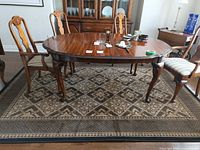 Full view of rug under dining table showing overall design and size relative to furniture
