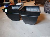 Two black fiberglass square planters side by side showing overall form