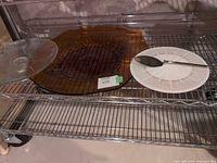 All three trays and cake server on wire shelf