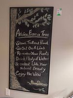 Full view of framed chalkboard art showing text and tree illustration