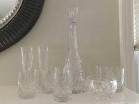 Decanter, eight glasses and candy bowl displayed together