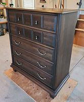 front three-quarter view of dresser showing block fronts and brass pulls