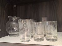 Pitcher, juice glasses and tumblers on shelf