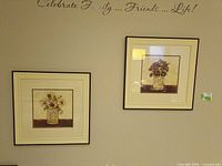 Both framed floral prints on wall showing design, matching mats and frames