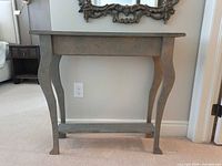 Front view of console table showing top, legs and lower shelf