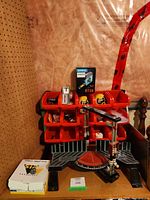 Overall view of bin rack, mitre box, boxed digital tape measure and tools