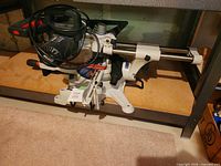 Full view of the King Canada sliding compound mitre saw under shelf