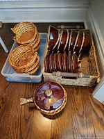 Overview of stacked ceramic bowls, wicker holders, and storage baskets