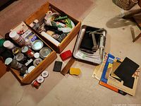 Overall lot with two wooden boxes of paint and stains, metal tray, sandpaper packages and tools
