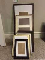 Stacked assortment of seven frames showing variety of sizes and finishes