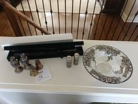 Group shot of bowl, cake cutter in case, and all shakers