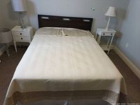 Comforter and shams displayed on queen bed