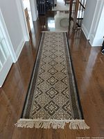 Full length view of runner rug on hardwood floor