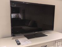 Front view of Samsung 46-inch LED TV on stand atop cabinet