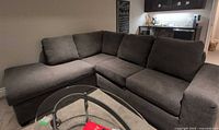 Full view of charcoal sectional sofa in room